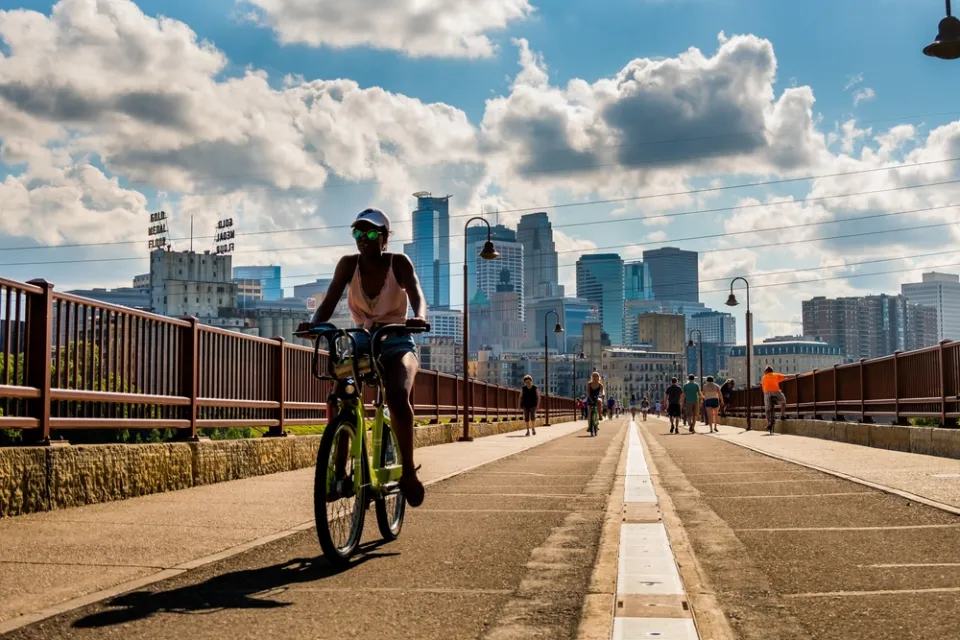 Bike on bridge in Minneapolis with skyline in background